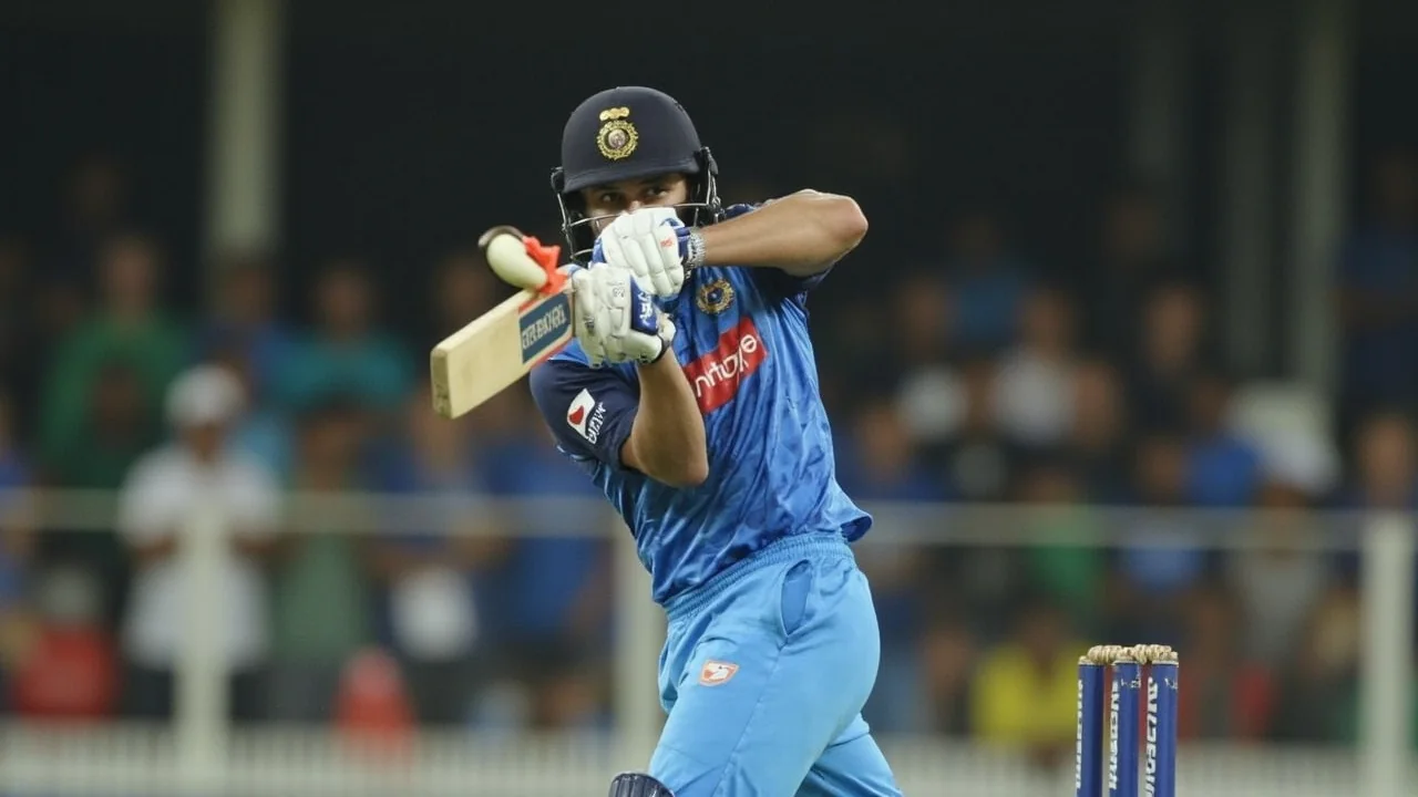 A women's T20I batter in follow-through after a cover-drive at Edgbaston, with the Edgbaston pitch and fielding ring visible in the background